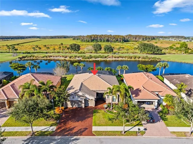 an aerial view of residential houses with outdoor space and ocean view