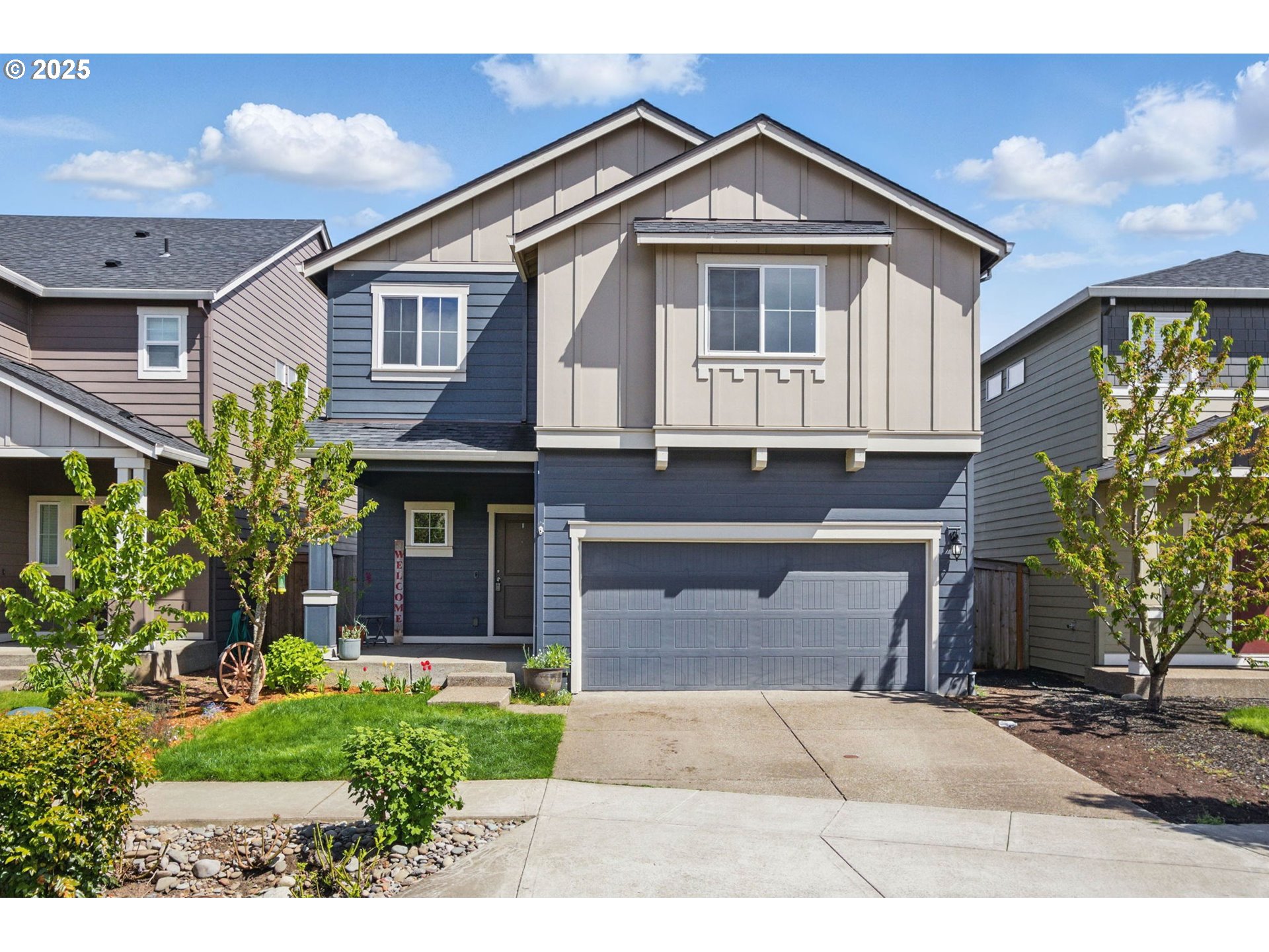 a front view of a house with a yard and garage