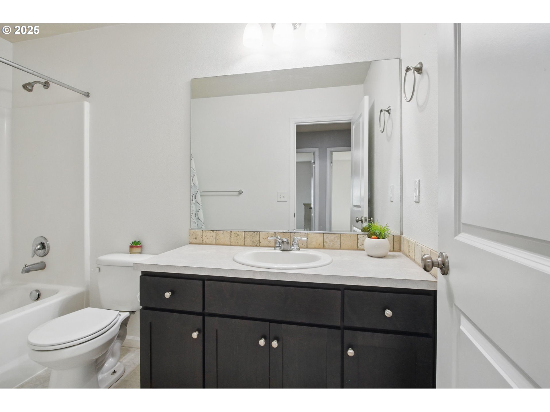 262 North 34th Court Ridgefield, WA 98642 - Photo 20 of 27 a bathroom with a sink vanity granite toilet and a mirror