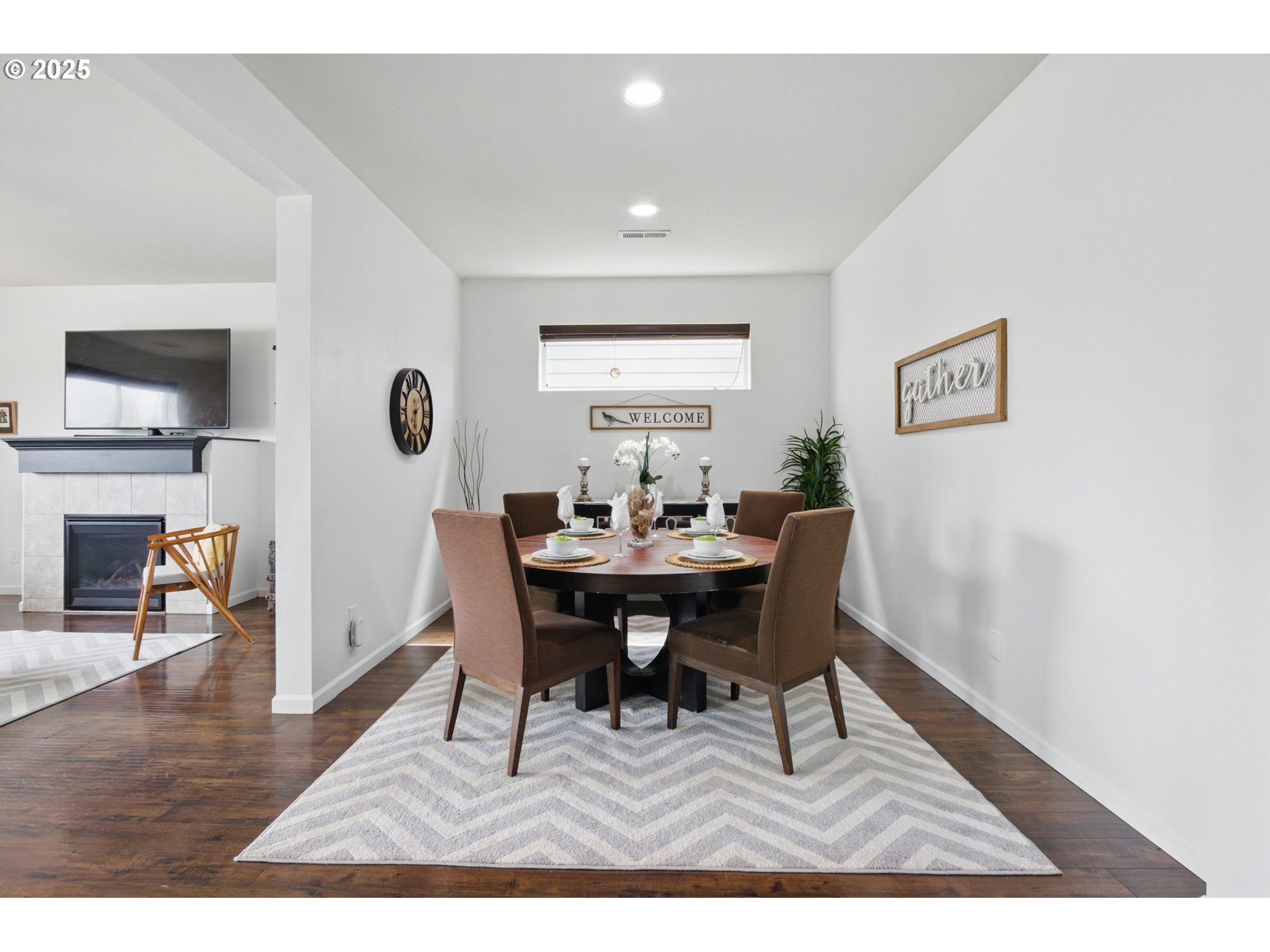 262 North 34th Court Ridgefield, WA 98642 - Photo 6 of 27 a view of a dining room with furniture and wooden floor