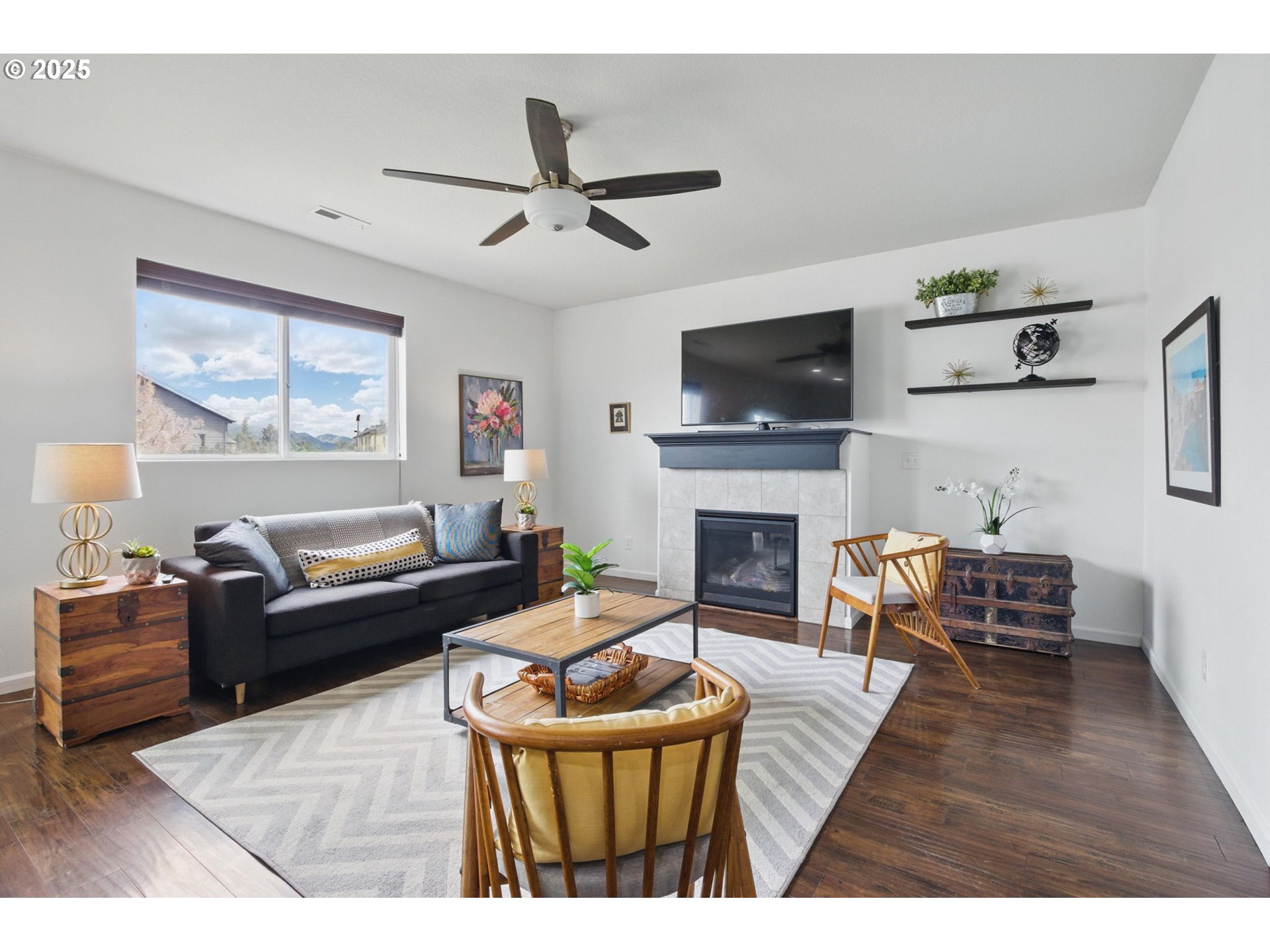 262 North 34th Court Ridgefield, WA 98642 - Photo 8 of 27 a living room with furniture a flat screen tv and a fireplace