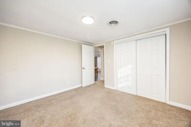 a spacious bedroom with a bed and a window
