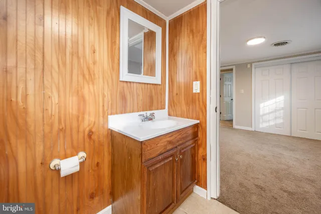 a spacious bedroom with a bed and a chandelier