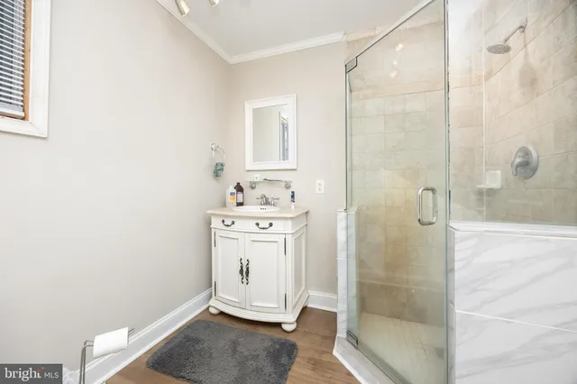 a bathroom with a sink a toilet and a window