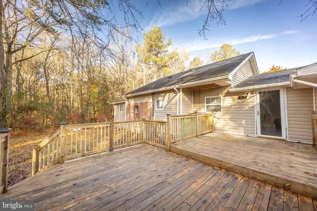 a backyard of a house with large trees and barbeque oven