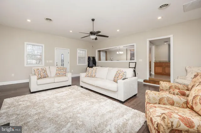 a spacious bedroom with a bed and wooden floor