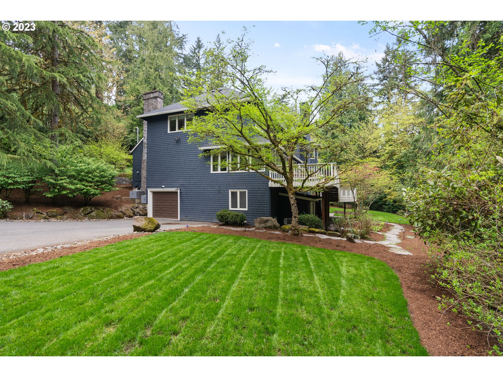 1991 South Palatine Hill Road Portland, OR 97219 - Photo 47 of 48 a front view of a house with a yard and trees