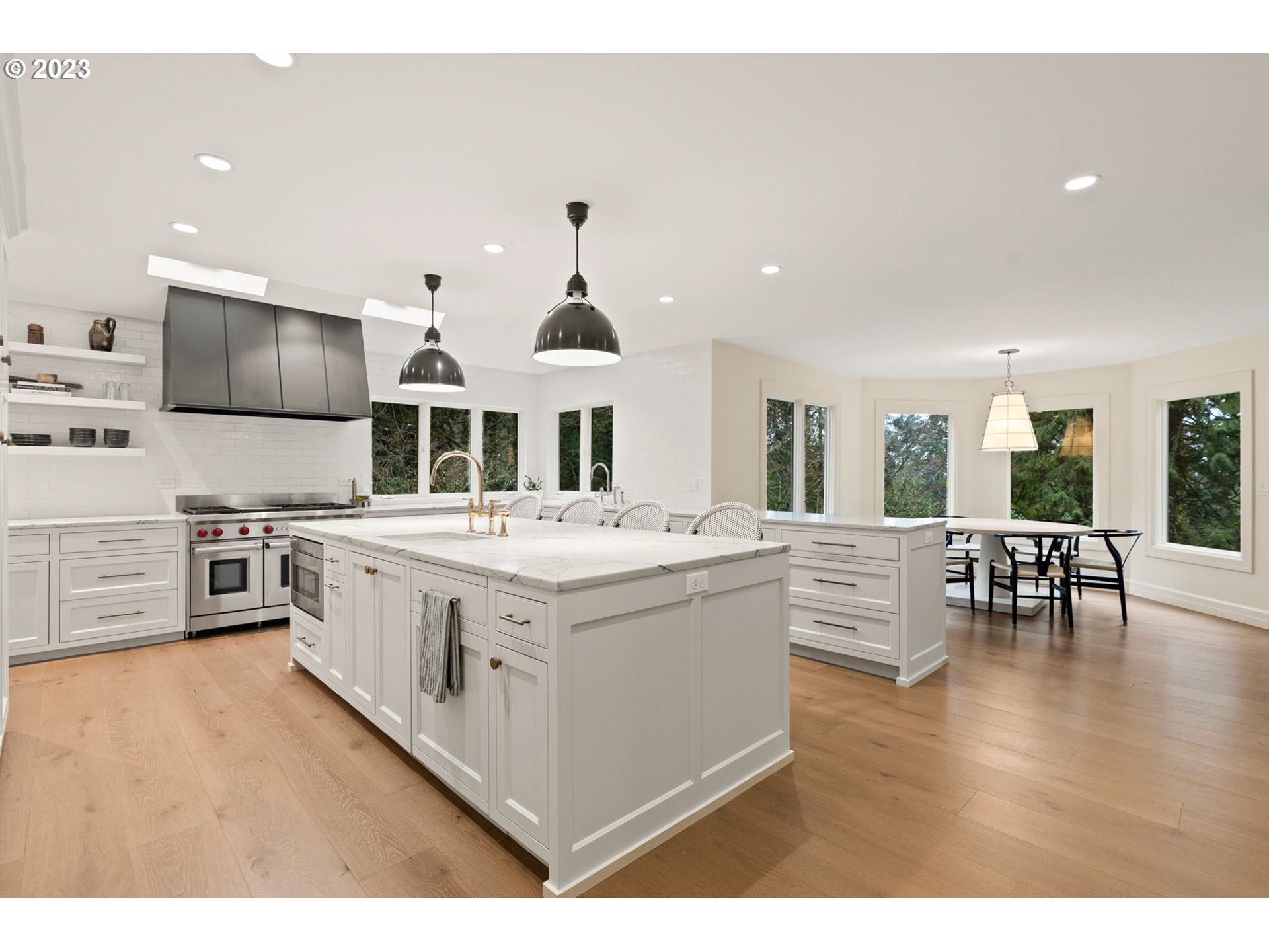 1991 South Palatine Hill Road Portland, OR 97219 - Photo 8 of 48 a large white kitchen with stainless steel appliances kitchen island granite countertop a large kitchen island and a couch
