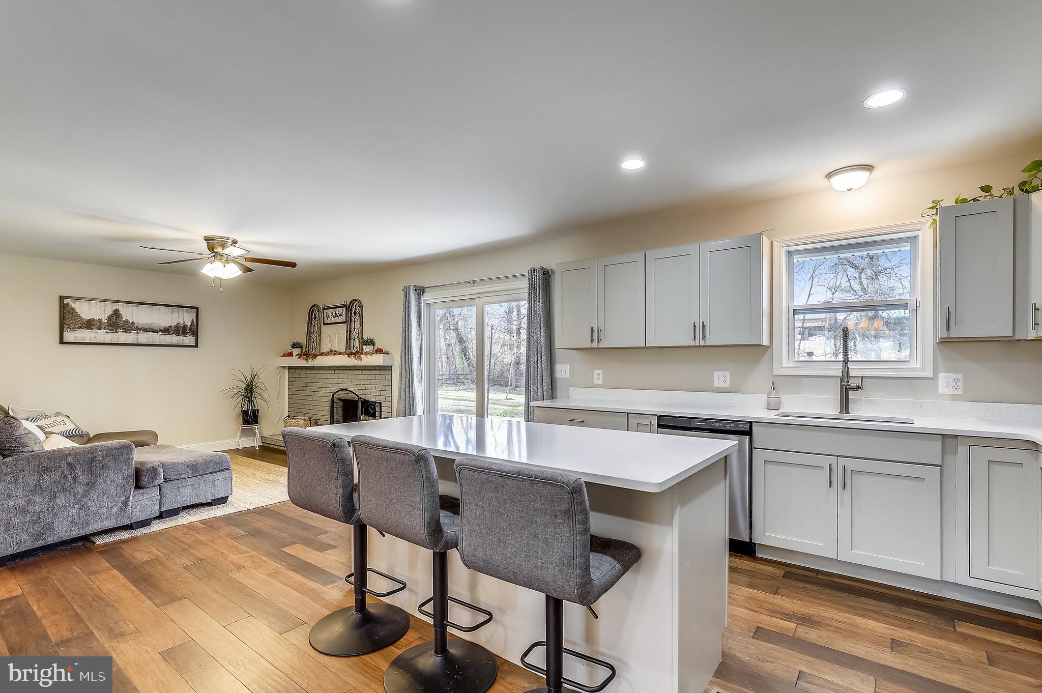 9426 Boyds Turn Road Owings, MD 20736 - Photo 5 of 27 a kitchen with a table chairs refrigerator and cabinets