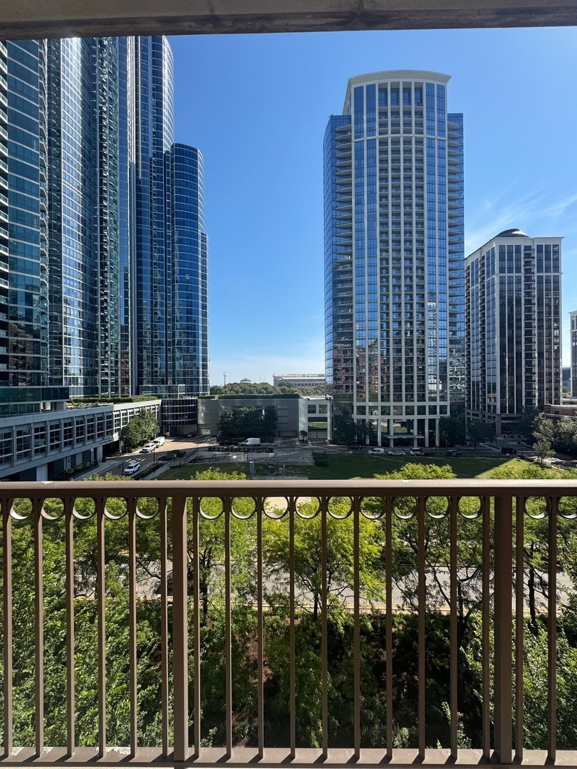 1250 South Indiana Avenue, Unit 702 Chicago, IL 60605 - Photo 18 of 22 a view of balcony with a floor to ceiling window and tall tree