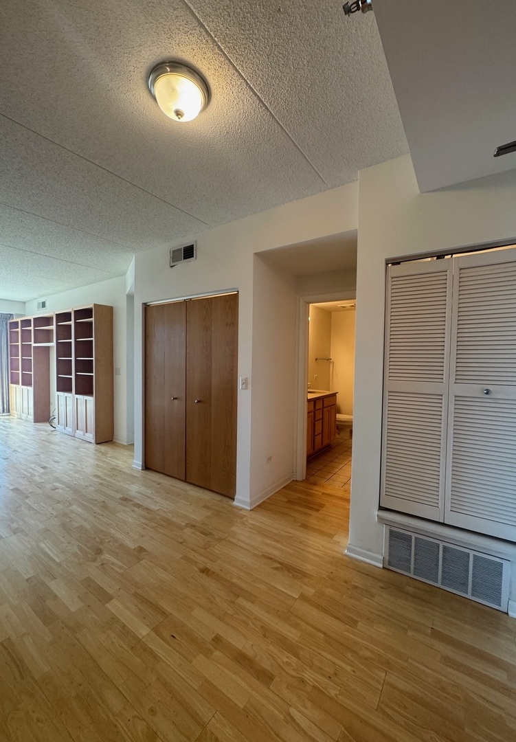 1250 South Indiana Avenue, Unit 702 Chicago, IL 60605 - Photo 4 of 22 a view of empty room with wooden floor