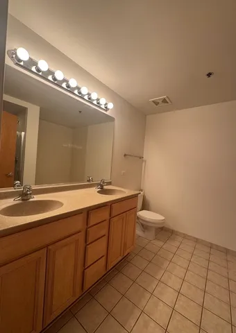 a bathroom with a double vanity sink and a mirror
