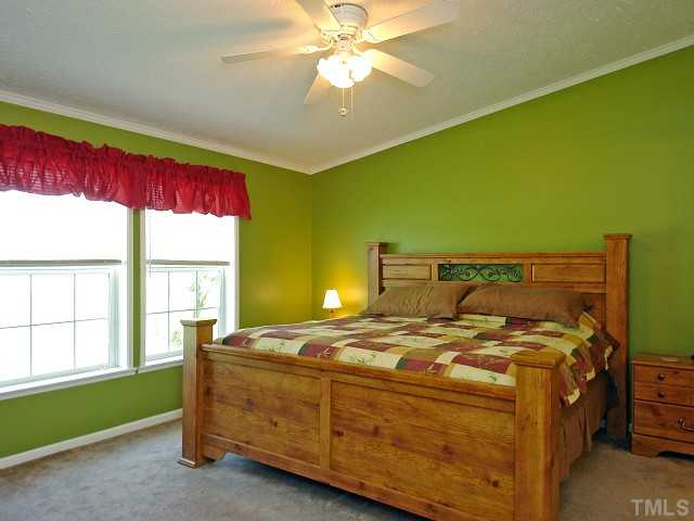 10829 Old Raleigh-Wilson Road Middlesex, NC 27557 - Photo 6 of 12 a bed sitting in a room next to a window