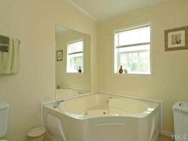 10829 Old Raleigh-Wilson Road Middlesex, NC 27557 - Photo 7 of 12 a white bath tub sitting next to a white toilet
