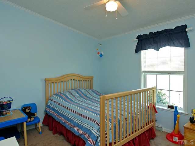10829 Old Raleigh-Wilson Road Middlesex, NC 27557 - Photo 8 of 12 a view of a bedroom with furniture and a window
