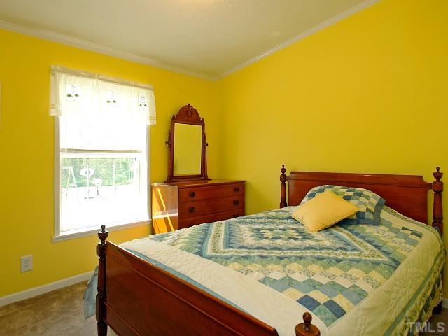 10829 Old Raleigh-Wilson Road Middlesex, NC 27557 - Photo 9 of 12 a bedroom with a bed and teddy bear on bed