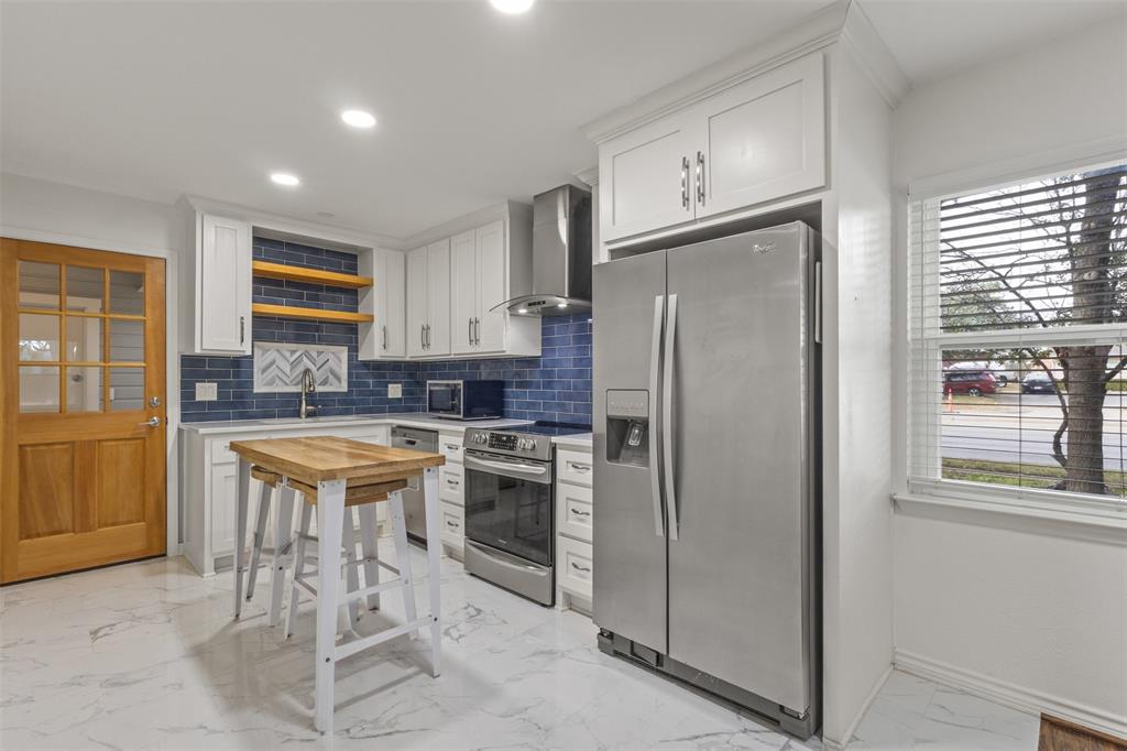 10879 Cassandra Way Dallas, TX 75228 - Photo 12 of 36 a kitchen with stainless steel appliances granite countertop a refrigerator and a stove top oven