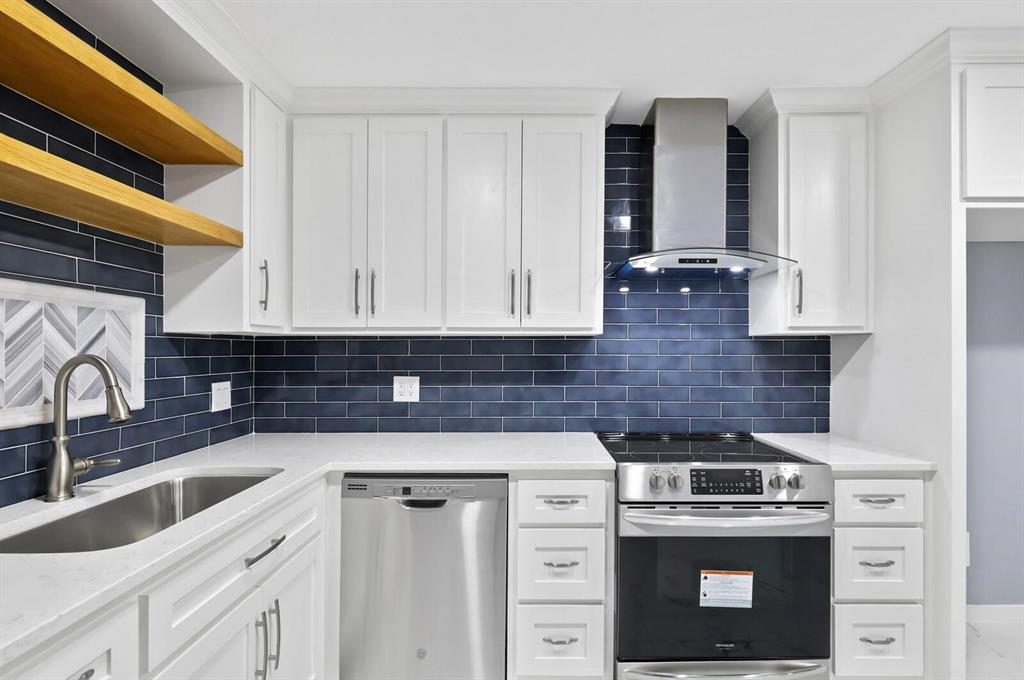 10879 Cassandra Way Dallas, TX 75228 - Photo 13 of 36 a kitchen with granite countertop a sink a stove and cabinets