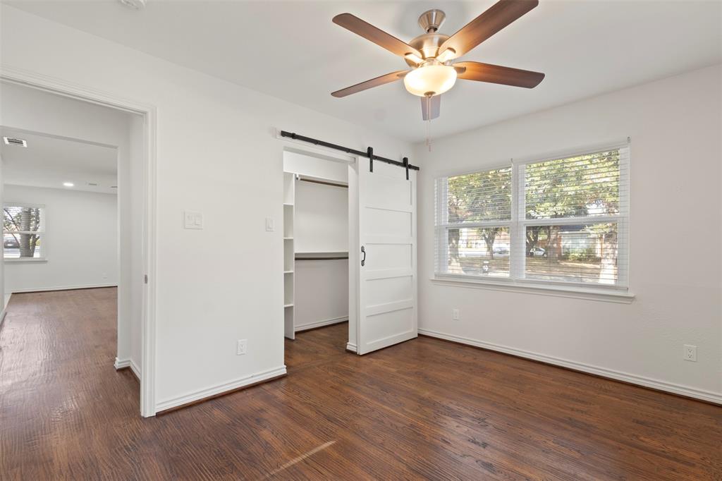 10879 Cassandra Way Dallas, TX 75228 - Photo 21 of 36 a view of an empty room with a window and wooden floor
