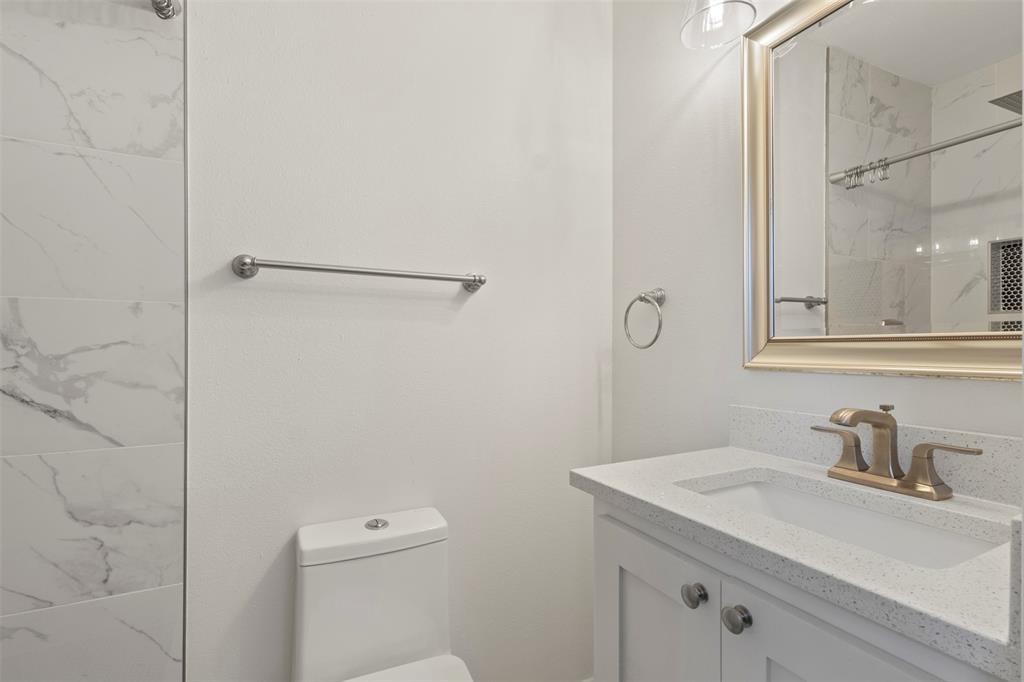 10879 Cassandra Way Dallas, TX 75228 - Photo 22 of 36 a bathroom with a sink toilet and vanity
