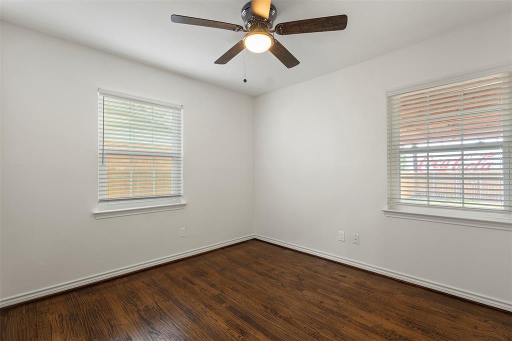 10879 Cassandra Way Dallas, TX 75228 - Photo 24 of 36 a view of an empty room with wooden floor and a window