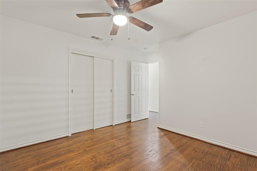 10879 Cassandra Way Dallas, TX 75228 - Photo 28 of 36 an empty room with wooden floor fan and windows