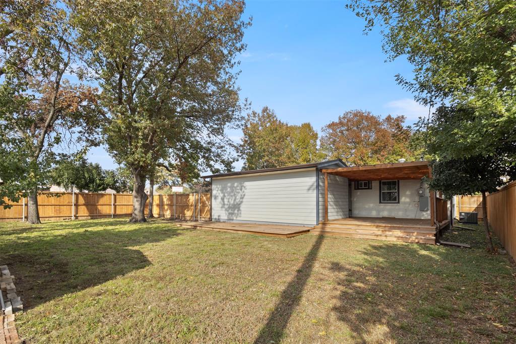 10879 Cassandra Way Dallas, TX 75228 - Photo 33 of 36 a front view of house with yard and trees all around