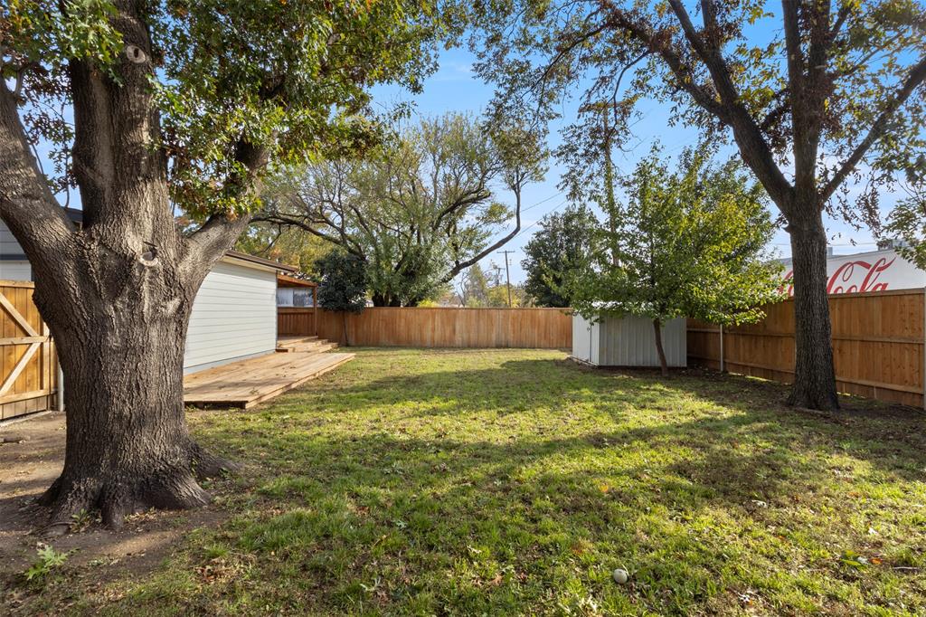 10879 Cassandra Way Dallas, TX 75228 - Photo 35 of 36 a backyard of a house with lots of green space