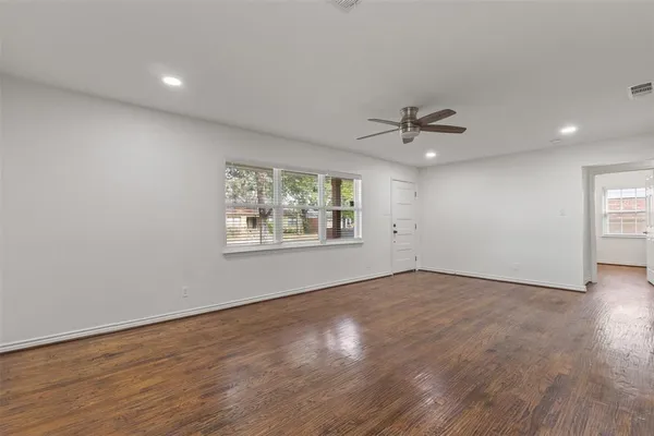wooden floor in an empty room with a window