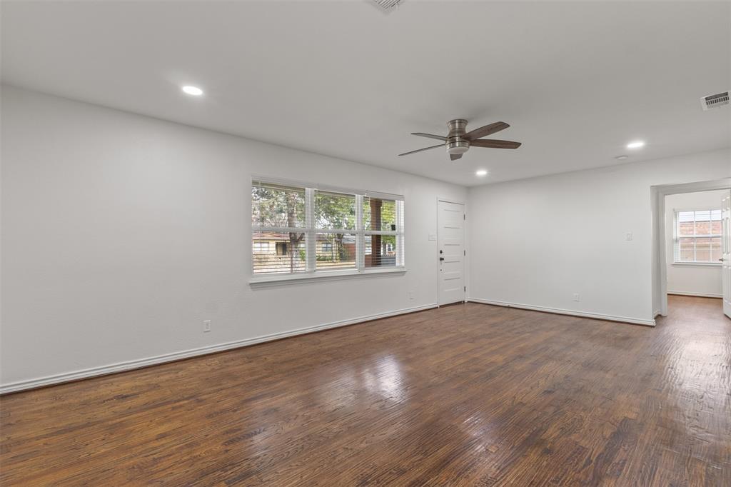 10879 Cassandra Way Dallas, TX 75228 - Photo 7 of 36 wooden floor in an empty room with a window