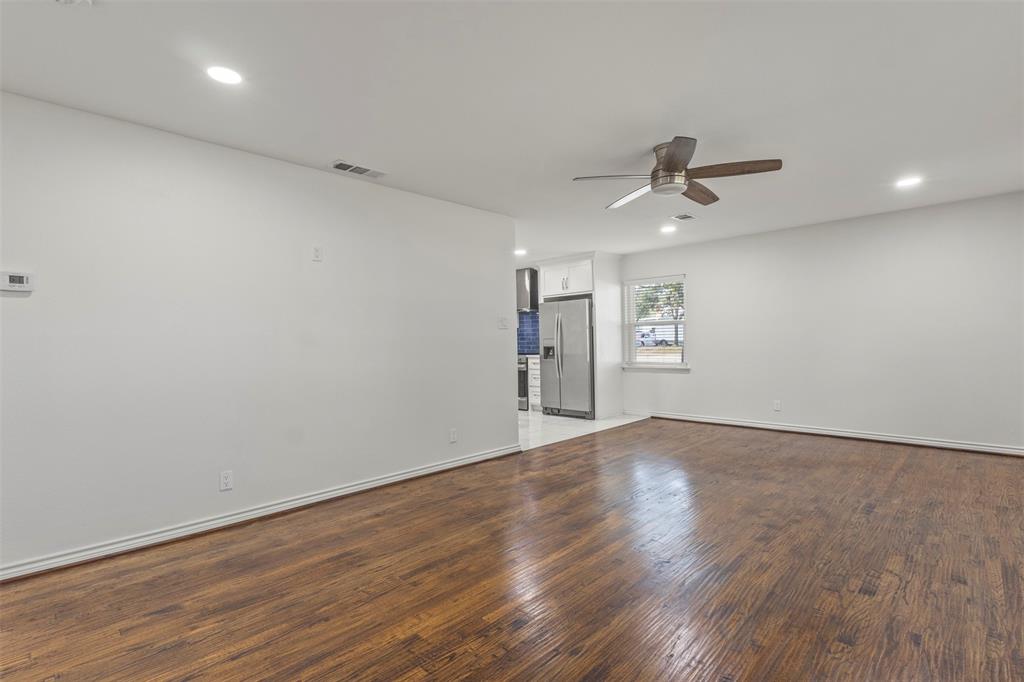 10879 Cassandra Way Dallas, TX 75228 - Photo 9 of 36 a view of empty room with wooden floor and ceiling fan