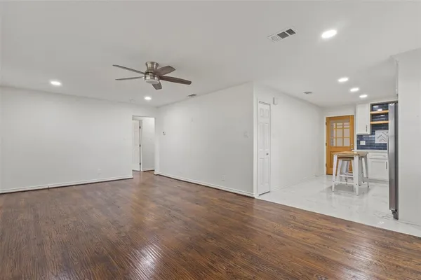a view of work space with wooden floor and a ceiling fan