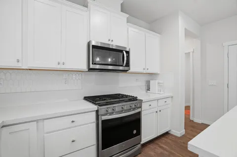 a kitchen with a sink stove and cabinets