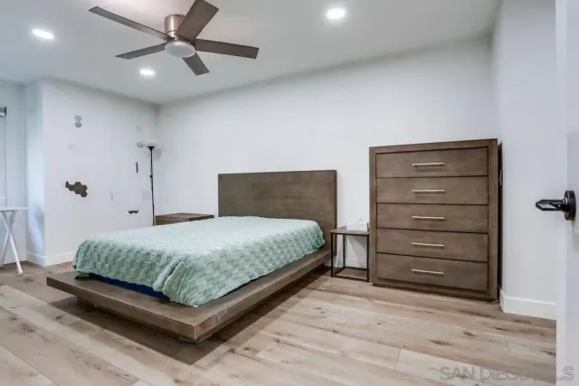 a bedroom with a bed and a dresser