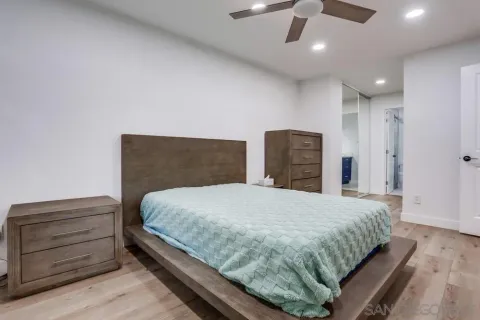 a bedroom with a bed and a ceiling fan