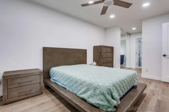 a bedroom with a bed and a ceiling fan