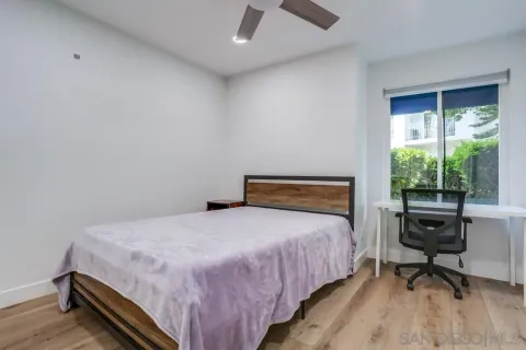 a bedroom with a bed and a desk