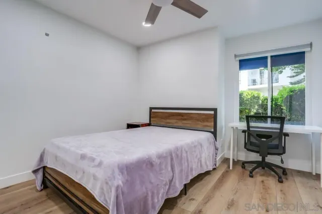 a bedroom with a bed and a desk