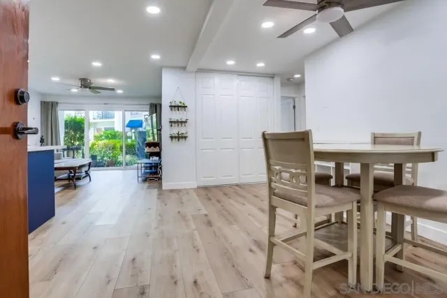 a view of a dining room with furniture and a floor to ceiling window