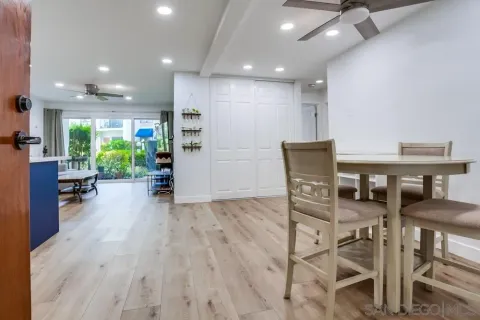 a view of a dining room with furniture and a floor to ceiling window