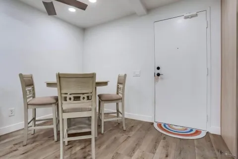 a view of a room with wooden floor table and chair