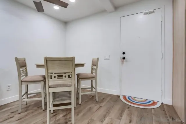a view of a room with wooden floor table and chair