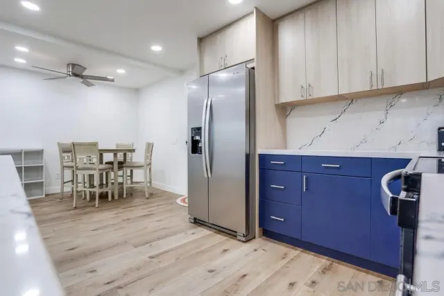 a view of a kitchen with dining table and chairs