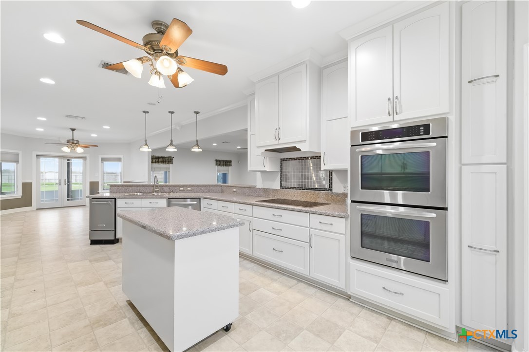 1118 East Maxwell Ditch Road Port Lavaca, TX 77979 - Photo 12 of 36 a kitchen with stainless steel appliances granite countertop a stove and a microwave