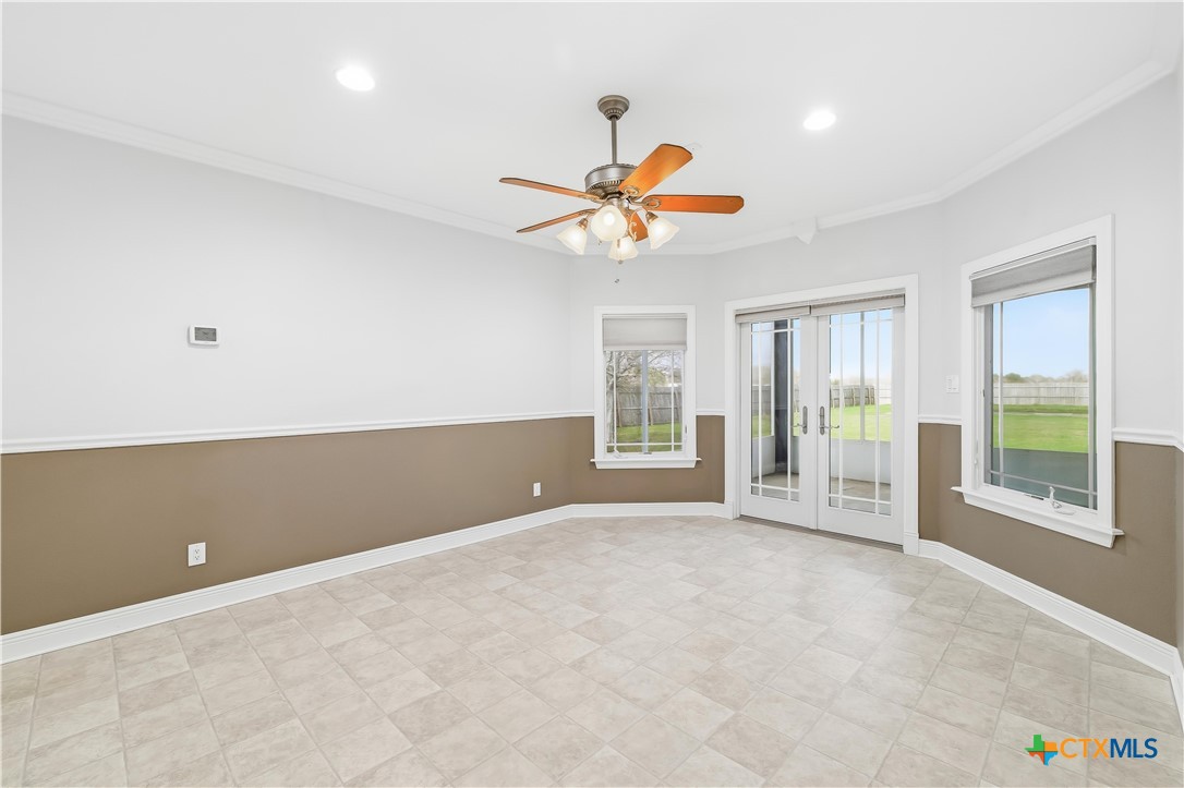 1118 East Maxwell Ditch Road Port Lavaca, TX 77979 - Photo 16 of 36 an empty room with windows and fan