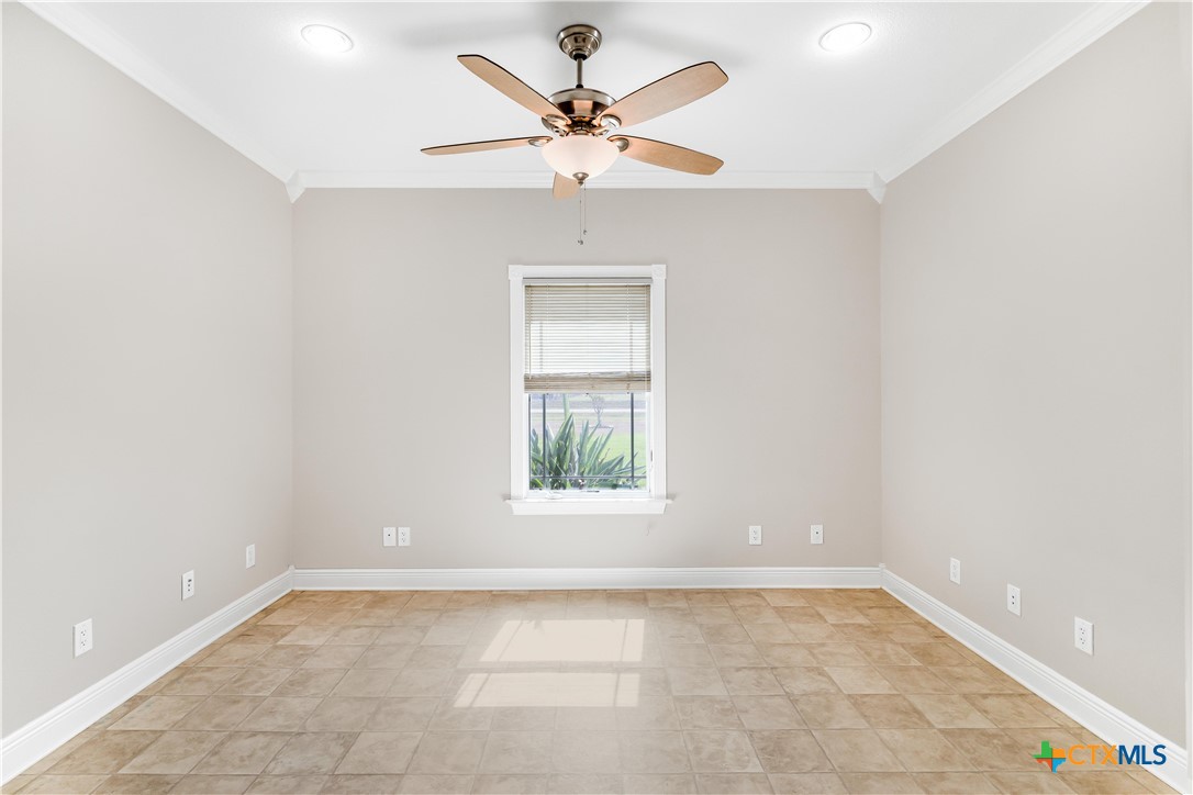 1118 East Maxwell Ditch Road Port Lavaca, TX 77979 - Photo 17 of 36 an empty room with a window and a ceiling fan