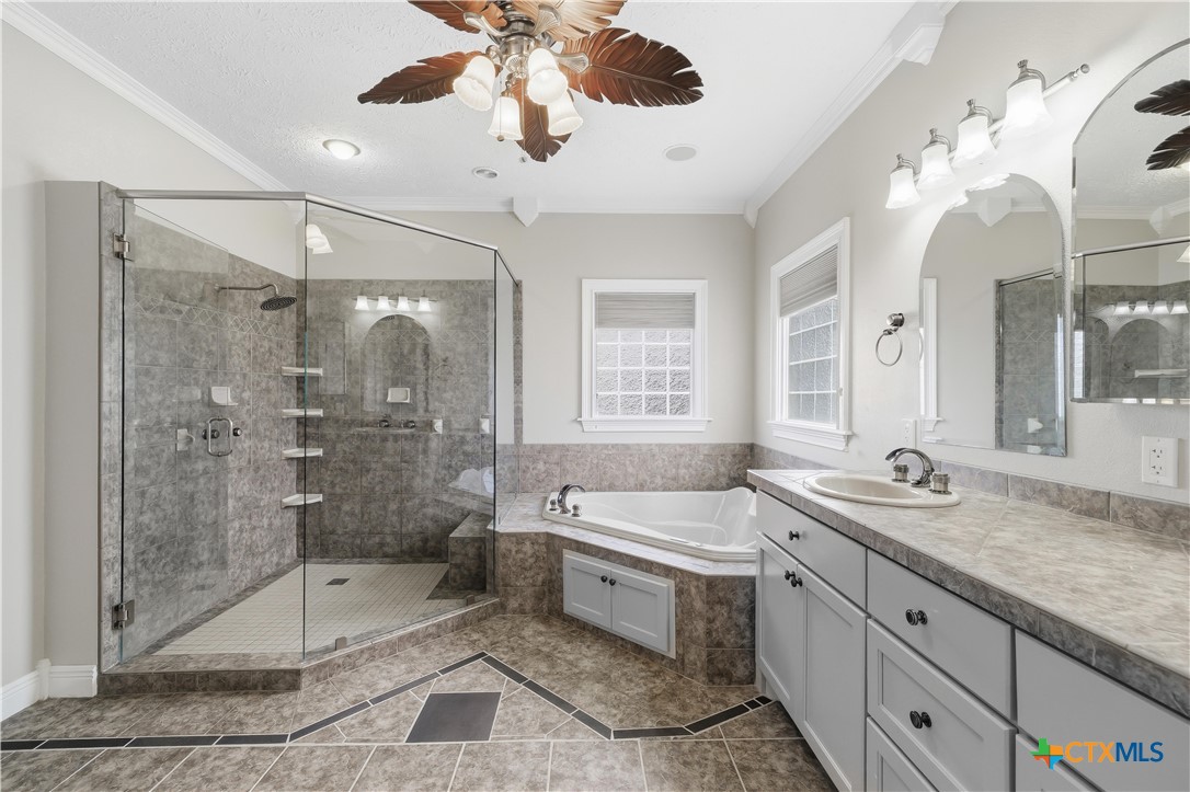 1118 East Maxwell Ditch Road Port Lavaca, TX 77979 - Photo 22 of 36 a spacious bathroom with a granite countertop sink mirror and shower