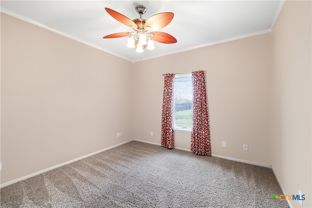 1118 East Maxwell Ditch Road Port Lavaca, TX 77979 - Photo 23 of 36 an empty room with windows and ceiling fan