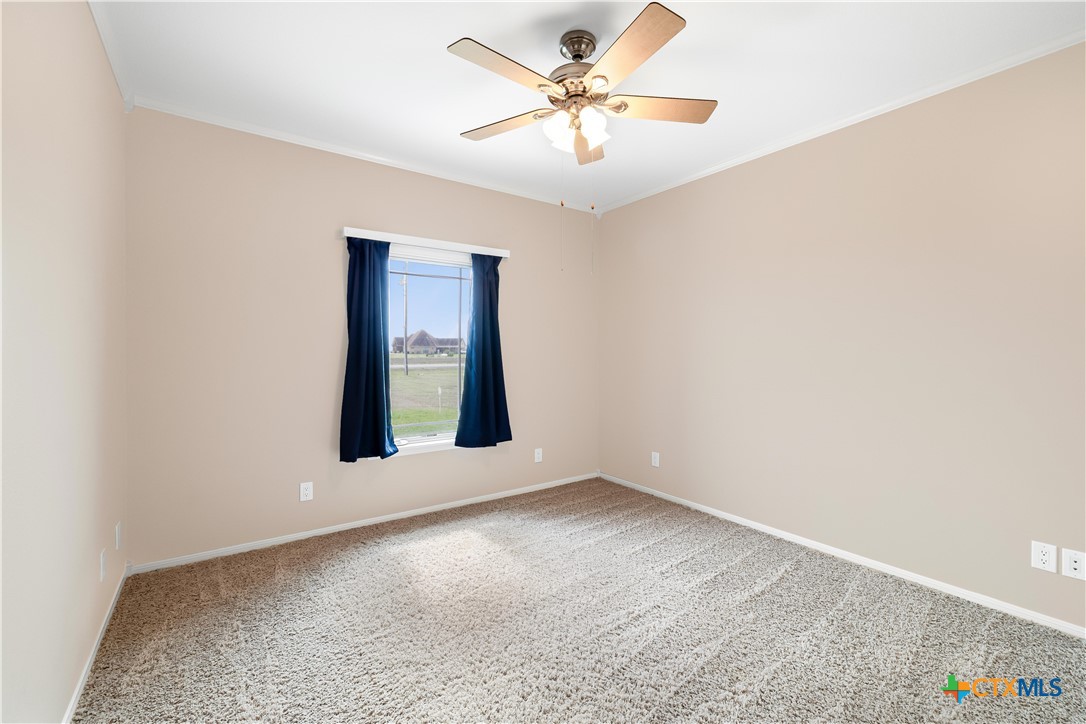 1118 East Maxwell Ditch Road Port Lavaca, TX 77979 - Photo 24 of 36 an empty room with a window and a ceiling fan