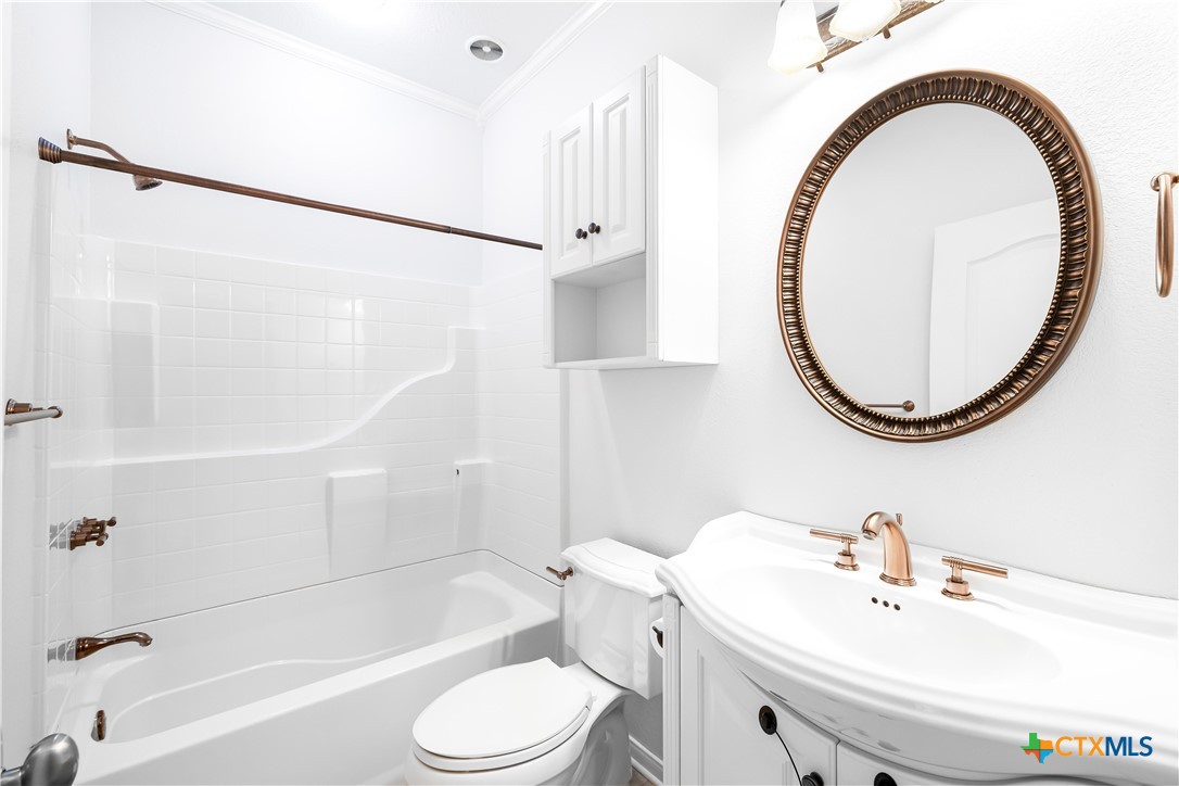 1118 East Maxwell Ditch Road Port Lavaca, TX 77979 - Photo 27 of 36 a bathroom with a sink a toilet and a mirror